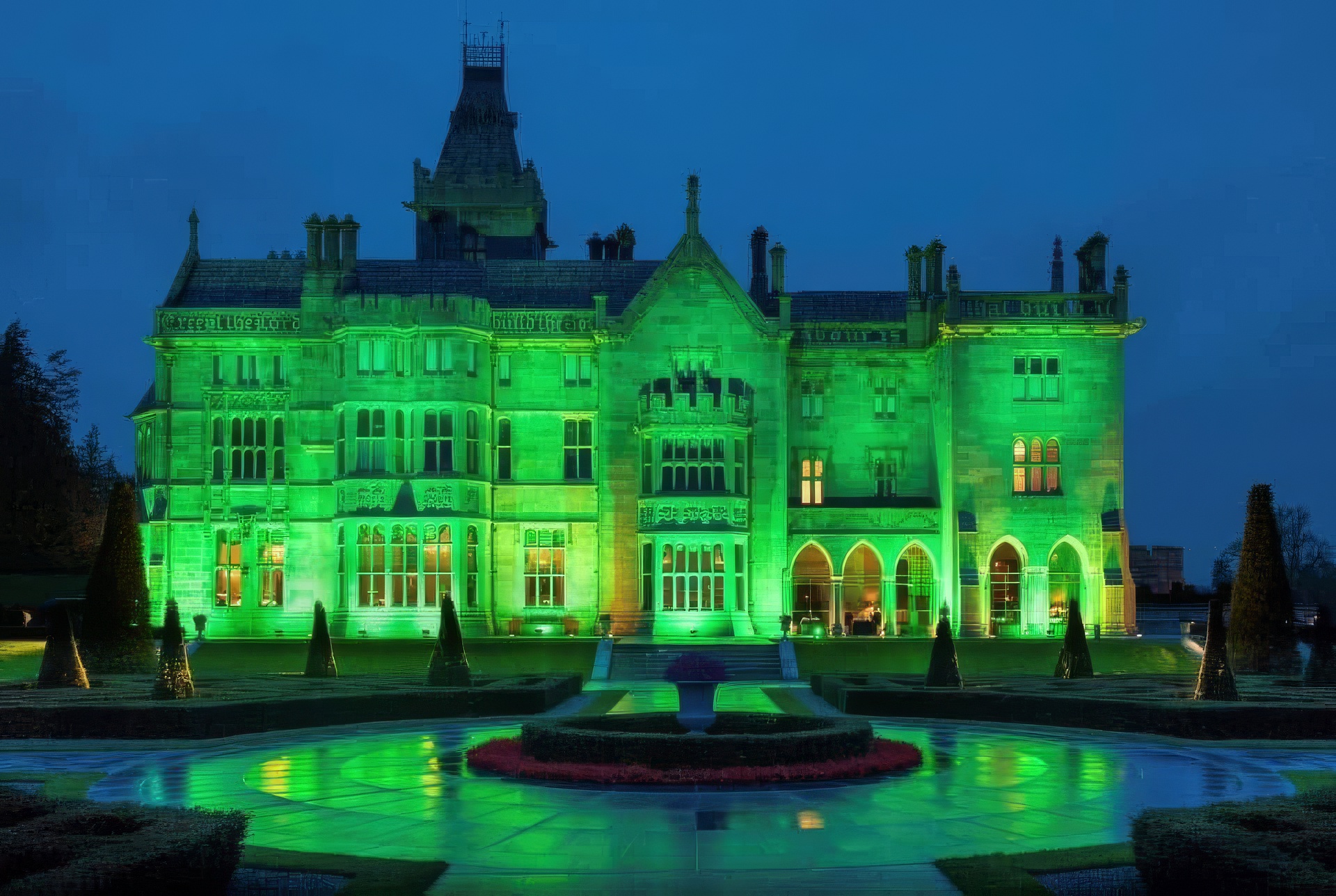 Adare Manor lit up green for St. Patrick's Day with building and facade lighting